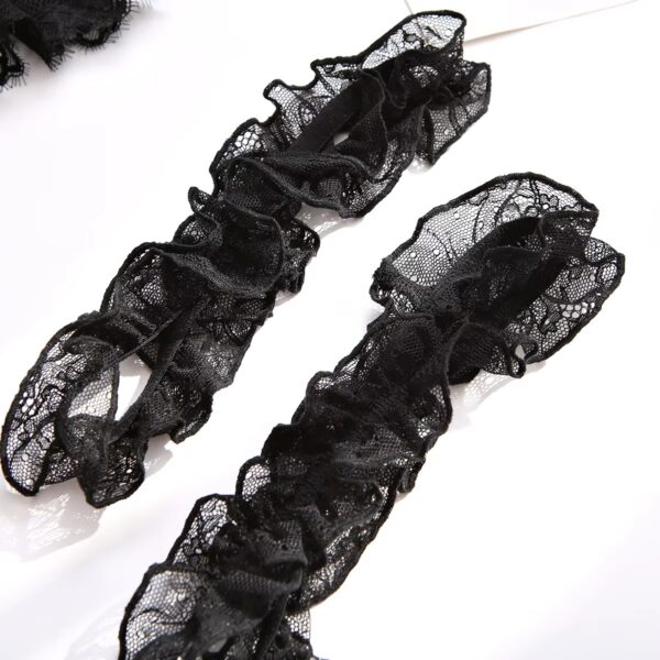 Close-up of the black garters, highlighting their fine design and adding an elegant touch to the lingerie set.