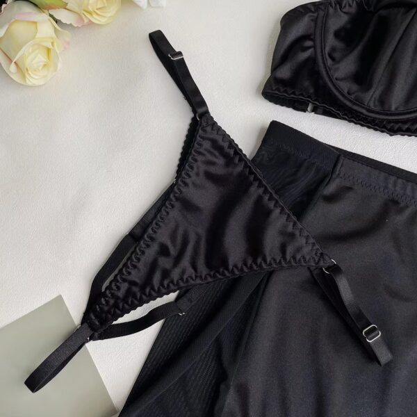 Close-up of the black thong and skirt, highlighting the sensual, mysterious design in the lingerie set.