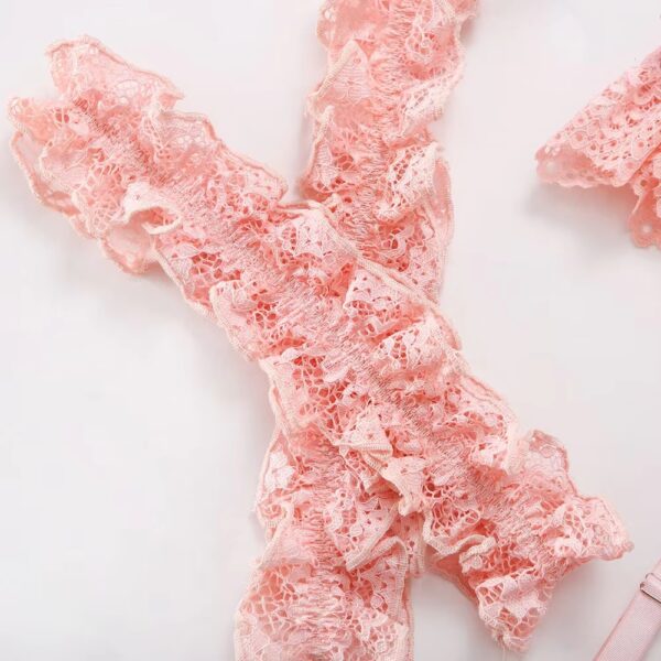 Close-up of the pink garters, emphasizing the romantic and delicate design of the lingerie set.