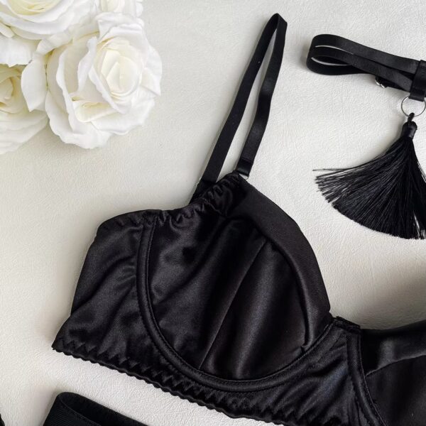 Close-up of the black bra, emphasizing the sensual and mysterious details of the design.