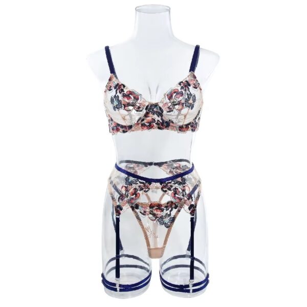 Full view of a floral embroidered lingerie set with blue trim, including a bra, thong, garter belt, and garters, featuring a playful and seductive design.