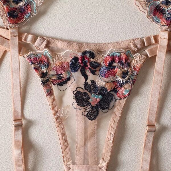 Close-up of the cream-colored thong from a floral embroidered lingerie set, highlighting the intricate embroidery and delicate design.