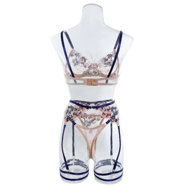 Full view of a floral embroidered lingerie set with blue trim, including a bra, thong, garter belt, and garters, designed for a bold and playful look.