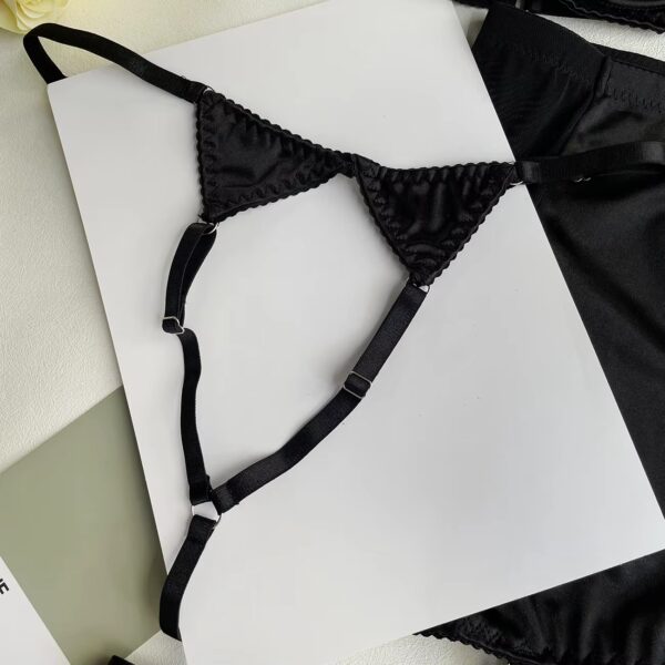 Close-up of the black collar, adding a sensual and mysterious touch to the lingerie set.