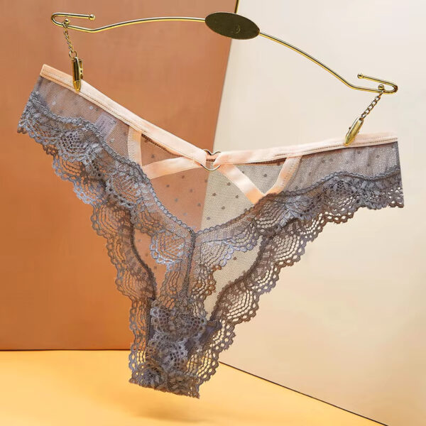 Close-up of the grey lace thong featuring a small metallic heart detail on the back, adding a touch of charm and sensuality to the design.