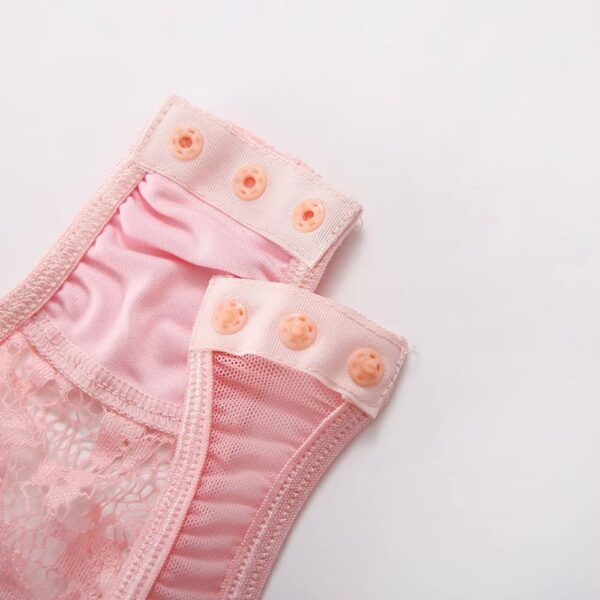 Close-up of the button closure on the bottom of the pink bodysuit, featuring delicate detailing for a romantic and sweet touch.