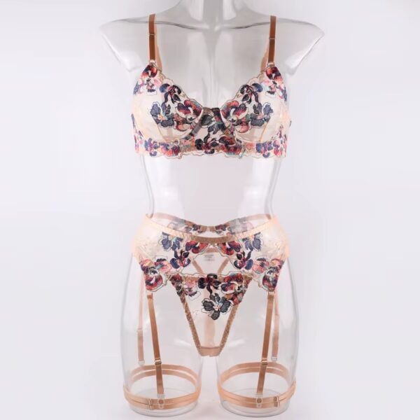 Full view of a floral embroidered lingerie set with cream trim, showcasing the feminine and elegant design of the bra, thong, garter belt, and garters.