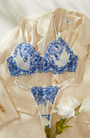 Blue floral embroidered lingerie set with sheer bra and thong, offering an elegant and seductive design.